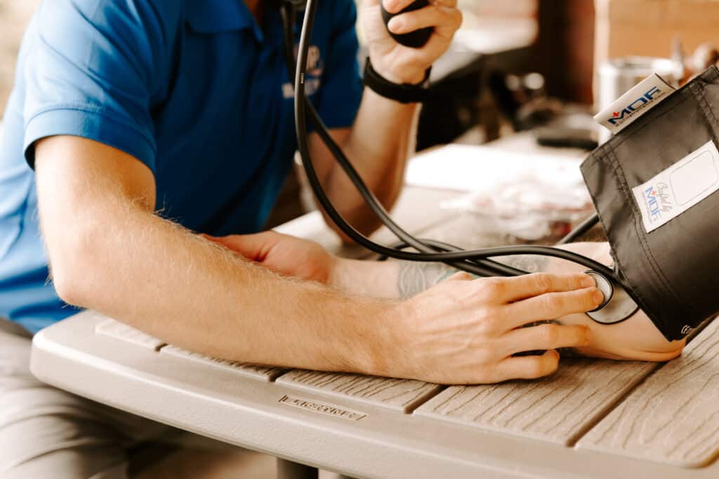 Mobile Physical Therapist - Charles checking blood pressure